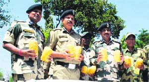 BSF officials show packets of heroin seized from the Indo-Pak border in Amritsar on Thursday