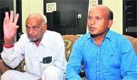 Gopi Ram (left), along with his son, at his home in Bathinda on Thursday. A Tribune photograph