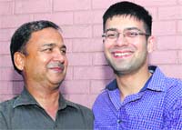 Gaurav Kaushal (right) is all smiles on his achievement in Chandigarh on Thursday. Tribune photo: Vicky Gharu