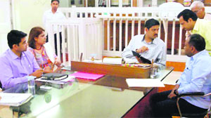 Deputy Commissioner Saket Kumar chairs a review meeting at his office in Ambala on Thursday.