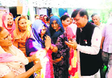 Cong candidate Rajinder Rana with voters at Jwar village in the Chintpurni segment on Thursday. 