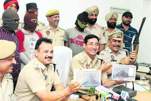 Police officials show weapons recovered from the gang of looters in Jalandhar on Thursday. 