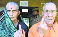 Brij Lal Raina and his wife Roopwati cast their vote at a special polling booth for displaced Kashmiri Hindus in Talab Tillo, Jammu, on Thursday. Tribune photo: Anand Sharma 