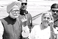 Prime Minister Manmohan Singh and his wife Gursharan Kaur after casting their votes at a polling station in Guwahati on Thursday