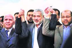 Fatah official Azzam al-Ahmad (L), Gaza's Hamas PM Ismail Haniyeh (C), and Hamas leader Moussa Abu Marzouk after the announcement of an agreement between the two rival Palestinian groups, at Shati Refugee Camp, Gaza Strip, on Wednesday.