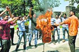 Activists of the Akhil Bharatiya Vidyarthi Parishad burn an effigy of the Vice Chancellor of the University of Jammu outside the main gate of the varsity
