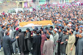 Villagers attend the funeral of poll official Mohammad Zia-ul-Haq in Shopian district on Friday