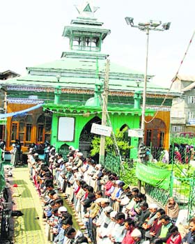 Devotees offer prayers at the shrine of Hazrat Sheikh Dawood during the annual Urs at Batamaloo in Srinagar on Friday