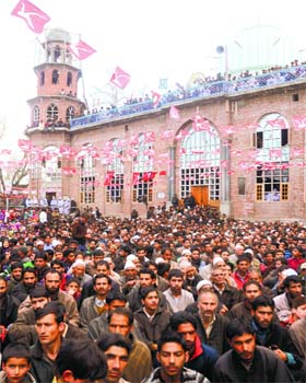 Poll fever: National Conference workers hoisted party flags on the dome of a pillar of Jamia Masjid during a rally of party candidate from Srinagar Farooq Abdullah at Waterhail village in Khanshaib, Budgam district, on Friday