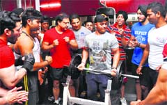 A participant lifts weight during a bicep competition at Prime Bodies Health Club in Ludhiana. A Tribune photograph