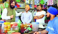Congress candidate Partap Singh Bajwa meets shopkeepers at Qadian in Gurdaspur. PTI photo
