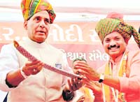 BJP chief Rajnath Singh being presented a sword during a public meeting in Kheda, Gujarat. PTI photo