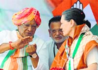 Congress candidate Shankersinh Vaghela with party chief Sonia Gandhi at an election rally. AFP photo