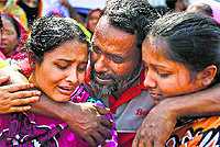 Relatives of victims mourn as they gather at the spot on the anniversary of last year's garment factory building collapse in Savar, near Dhaka, on Thursday