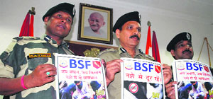 BSF officials, IG Punjab Frontier, Ajay Kumar Tomar (centre), DIG BSF MF Farooqui (right) release a poster to spread awareness against drug abuse in Amritsar on Saturday.