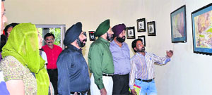 Local residents take a look at the paintings at Thakar Singh Art Gallery in Amritsar.
