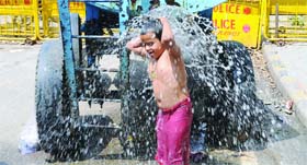 A child tries to beat the heat in New Delhi on Saturday.