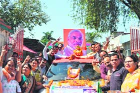 BJP workers during the Namo yatra at the party office in Dehradun on Saturday