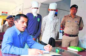 SSP Dr Sadanand Date with the two accused at the city police station in Haridwar on Saturday