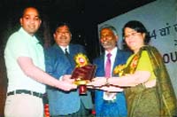 Dr Sumit Jarangal (left), Additional Commissioner, MC, receives an award from Anita Agnihotri, Secretary, Ministry of Urban Development, in New Delhi on Friday. a Tribune photograph