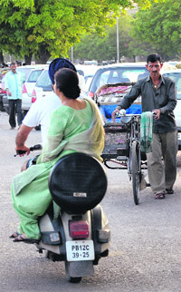 Two-wheelers use a cycle track on a road separating Sectors 42 and 43 on the Sector 43 side in Chandigarh