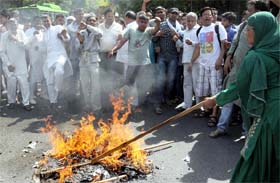 Activists from the Dalit community burning an effigy of Baba Ram Dev during a demonstration against his recent remark on Dalits, at Jantar Mantar in New Delhi on Sunday.