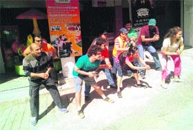 Members of a private company perform a street play in Mussoorie on Saturday