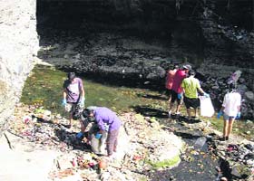 Volunteers of Making A Difference (MAD) clean the Tapkeshwar stream in Dehradun on Sunday