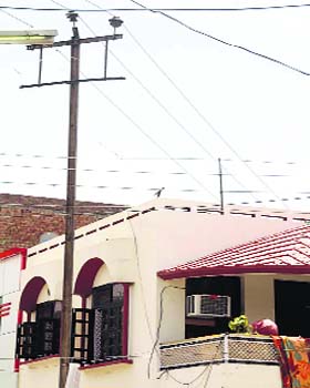 A high-tension electricity pole close to a house near sector 15 in Hisar