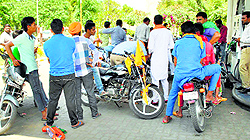 Young bikers get free-of-cost petrol at a filling station for 