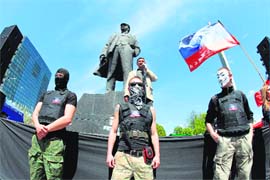 Pro-Russian activists guard a platform as a man delivers a speech at the feet of a Lenin statue, during a rally in the eastern Ukrainian city of Donetsk, on Sunday.