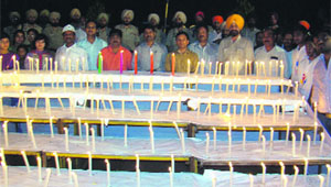 People take part in a candlelight ceremony at the Khalsa College grounds in Amritsar on Monday.