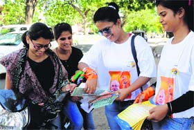 Supporters of the BJP distribute pamphlets of Narendra Modi in Mohali on Monday