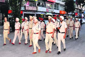 Police personnel stage a flag march in Phase VII, Mohali, on Monday