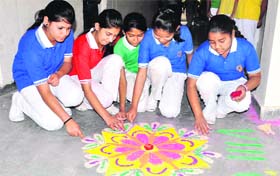 Students participate in a rangoli competition at Lucent International School in Dehradun on Monday.