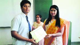 A student being awarded at the film-making competition at Delhi Public School in Dehradun on Monday.