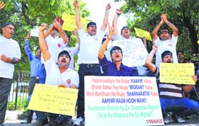 Kashmiri Pandit migrants, under the banner of the Youth All India Kashmiri Samaj, hold a protest in Jammu on Monday