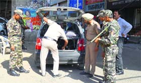 Personnel of paramilitary forces check vehicles in Ludhiana on Monday.