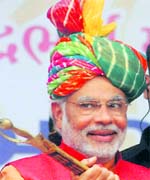 BJP PM candidate Narendra Modi holds a sword during a rally in Anand on Monday.