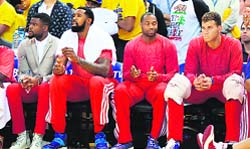 LA Clippers players sit on the bench wearing their warm-up tops inside out against the Golden State Warriors in Game Four of the Western Conference quarterfinals in Oakland on Sunday. AFP