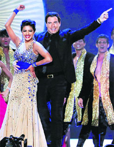 Hollywood star John Travolta dances with Bollywood actress Priyanka Chopra at the 15th IIFA Awards in Tampa on Saturday.