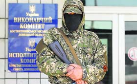 A pro-Russia armed man stands guard in front of the seized city council building in Kostyantynivka on Monday.