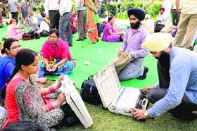 Polling officials check the EVMs before leaving for the election duty in Amritsar on Tuesday