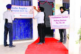 Polling officials put up welcome posters ahead of polls in Amritsar