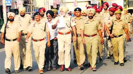 The police carry out a flag march in the city on Tuesday ahead of the Lok Sabha poll.