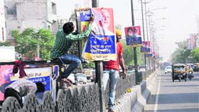 Posters of the SAD-BJP alliance being removed from poles on GT Road in Bathinda on Tuesday.