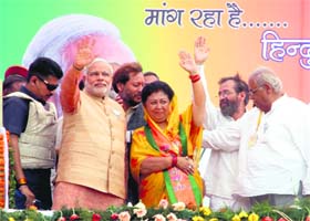 BJP prime ministerial candidate Narendra Modi with Tehri Garhwal candidate Mala Raj Lakshmi Shah during an election meeting at Herbertpur in Dehradun on Tuesday