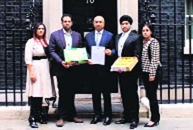 Leicester East MP Keith Vaz and representatives of mango traders before delivering Alphonso mangoes to British PM David Cameron at Downing Street in London on Tuesday