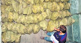 A poll official monitors bags of election material on the eve of Lok Sabha elections, in Patiala.