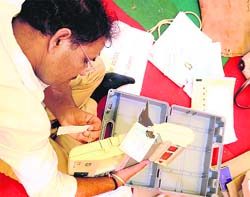 D-day is here: An election official checks an EVM before leaving for his polling station, in Ludhiana on Tuesday. Punjab votes on April 30.